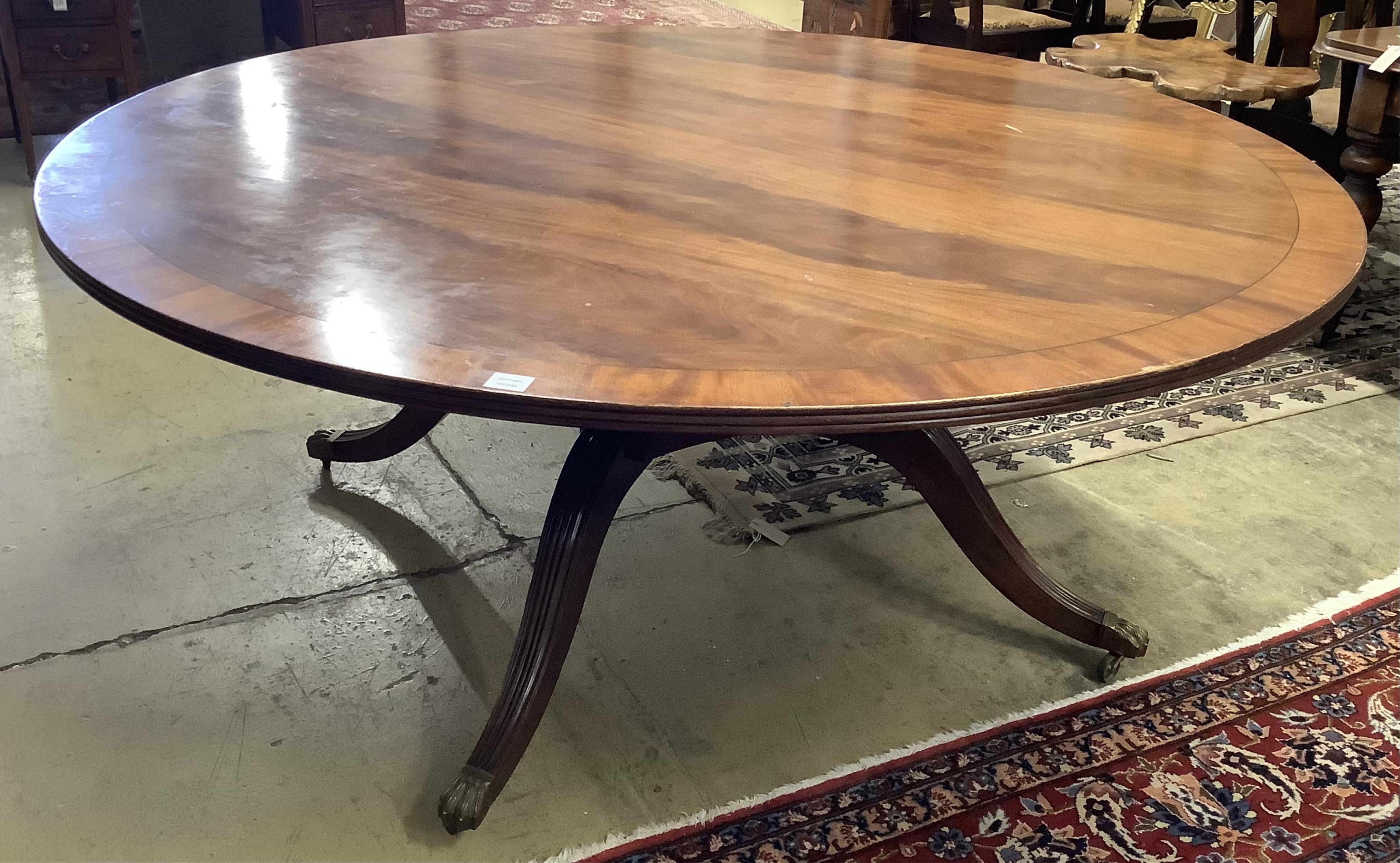 A reproduction George III style circular mahogany dining table, diameter 183cm, height 74cm